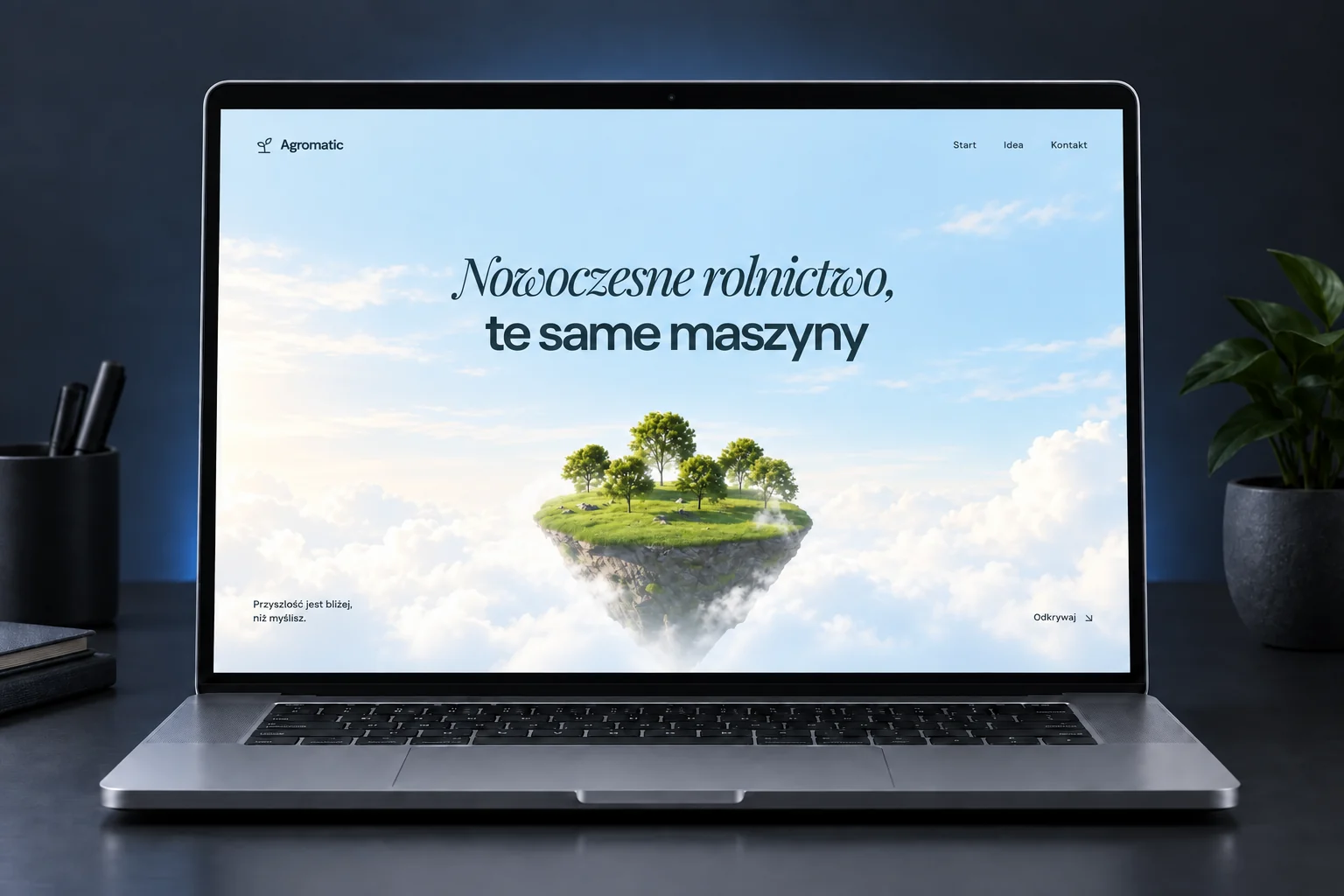 Strona główna Agromatic na laptopie: niebo, zielona wyspa i tytuł projektu.
